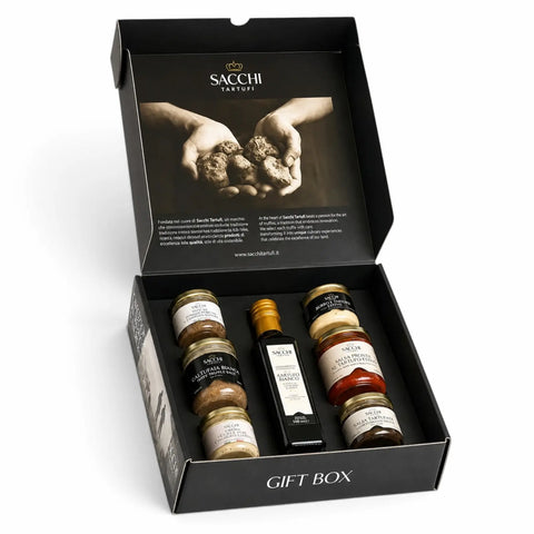 Caixa de presente aberta de trufas de luxo contendo sete produtos de trufas italianas