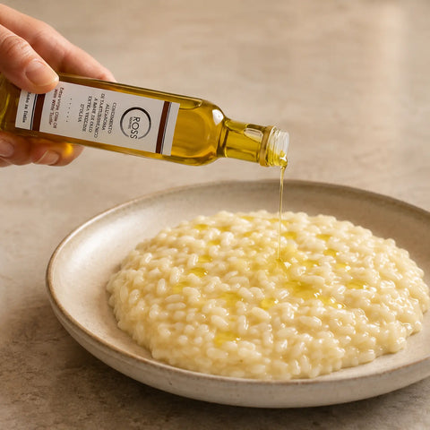 White Truffle Olive Oil being drizzled over warm creamy risotto